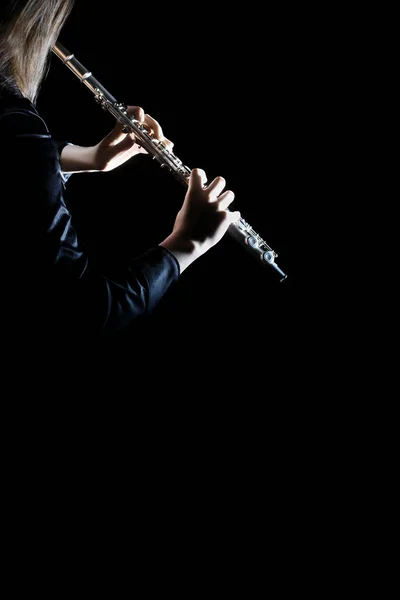 Flute instrument. Flutist hands playing flute isolated on black. Closeup of flute player