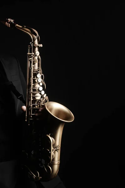 Saxophone player. Saxophonist hands playing jazz music instrument sax player