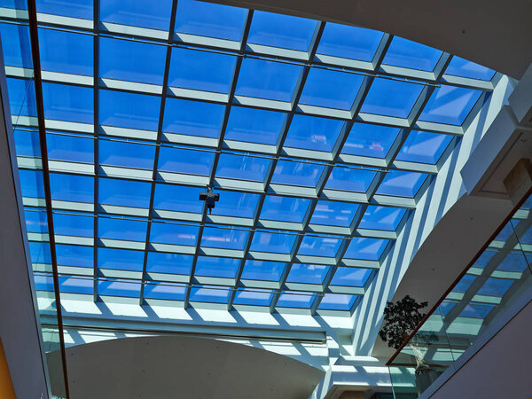 Glass roof of modern building with background of clear blue sky