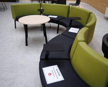 Waiting room with symbol on seat for the social distancing during the Covid-19 pandemic chairs with special warning signs - Svendborg Hospitalm, Denmark - 12 June 2020 clipart