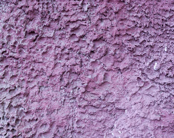 pink painted relief wall. background, texture.