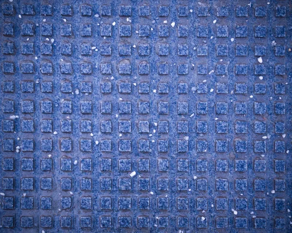 blue squared tile for blind pedestrians on the sidewalk with vignette. texture, background.