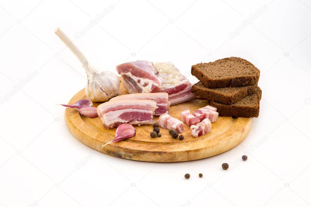 National Russian and Ukrainian food is salo. Sliced bacon on a wooden board. On a white background.