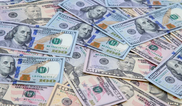 Background of dollar bills. American Dollars Cash Money. One hundred dollars, fifty dollars, ten dollars Banknotes.