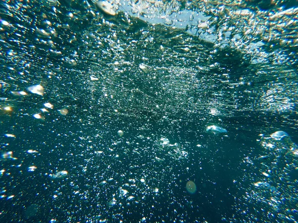 Las burbujas de aire bajo el agua se elevan. Hermosa textura de mar y agua del océano. Fondo azul aéreo. Fotografía submarina . —  Fotos de Stock