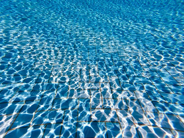 Água clara transparente na piscina. Foto subaquática da piscina reguladora. Fundo fundo da piscina de água azul. Tema de verão . — Fotografia de Stock