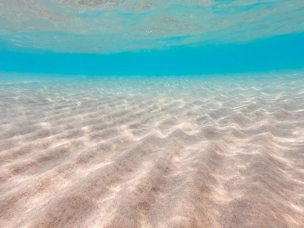 Underwater background with sandy sea bottom. Beautiful texture of the sea and ocean water. Pure water texture. — Stock Photo, Image