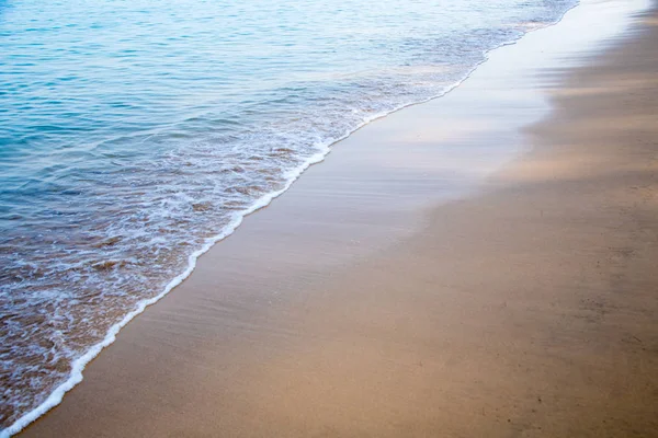 Spiaggia sabbiosa e onda blu del mare. Bellissimo sfondo naturale. Turismo e viaggi . — Foto Stock