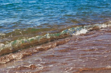 kumlu plaj ve mavi deniz dalgası. Güzel doğal arka plan. Turizm ve seyahat.