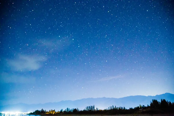 Starry sky and clouds. Over the high mountains. Natural background