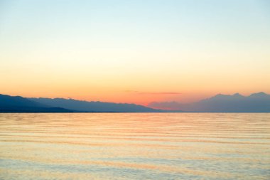 Denizde güneşin doğuşu. Dağların ardında yükselen güneş.