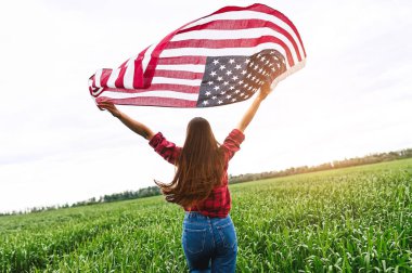 Kadın Amerikan bayrağıyla sahada koşuyor.