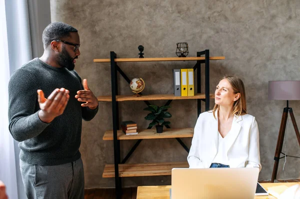 stock image Midshot of two multiracial colleagues in office