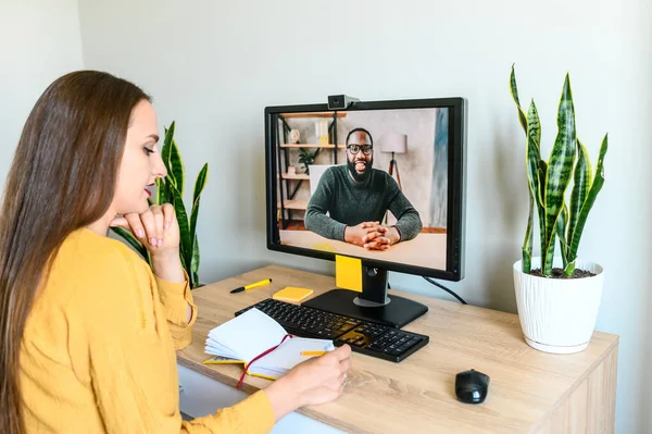 Video call. Young woman talks via video on PC