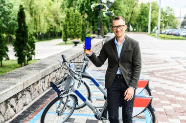 Bisiklet kiralama uygulaması kullanan akıllı bir adam.