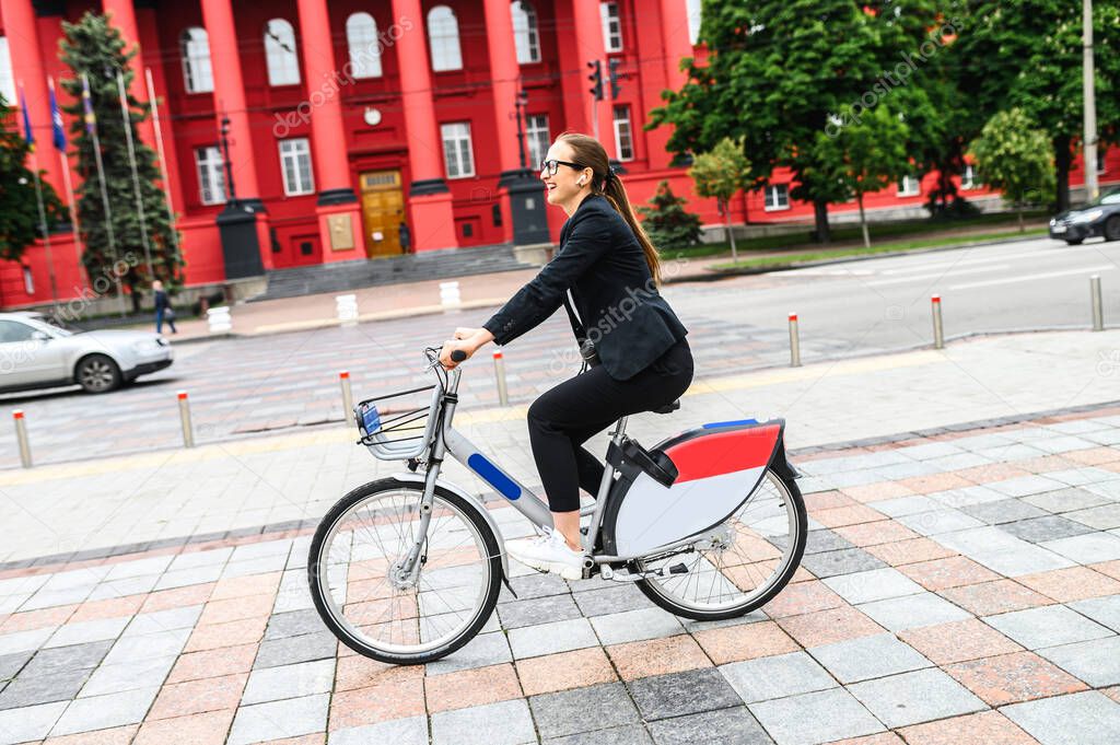 Girl in smart casual wear rides a bike