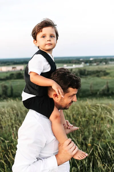 Babam yürümeye yeni başlayan çocuğu dışarıda omuzlarında taşıyor. — Stok fotoğraf