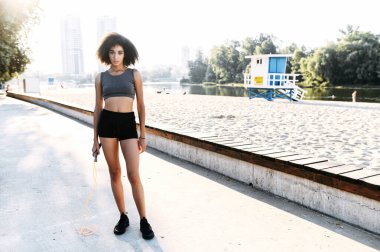 Dışarıda ip atlayan melez bir kız.