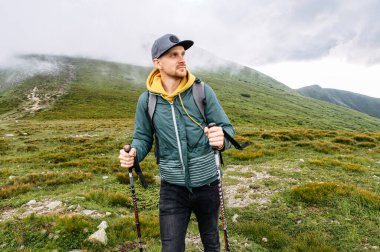 Sırt çantalı adam dışarıda kuzeyli yürüyüşü yapıyor.