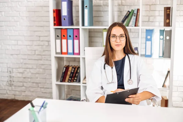 Female doctor with a clipboard indoors