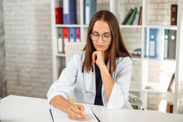 Female doctor with a clipboard indoors