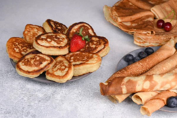 Old-fashioned fluffy pancakes and crepe with berries.