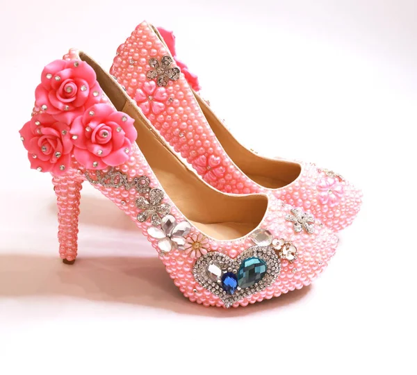 beautiful expensive wedding shoes in pearls and rhinestones with flowers