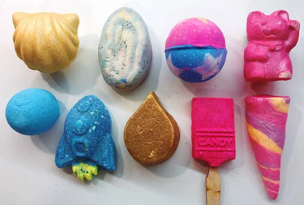 beautiful background of colored bath bombs in the form of ice cream, balls and a cat firm Lush