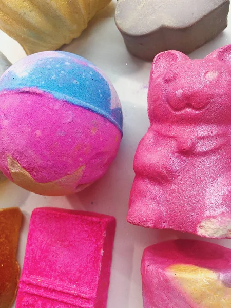 beautiful background of colored bath bombs in the form of ice cream, balls and a cat