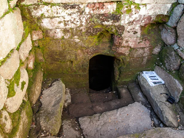 Sacred Source entrance archaeological site of Noddule in the megalithic circle and large circular hut in the new archaeological site in Sardinia , ITALY.