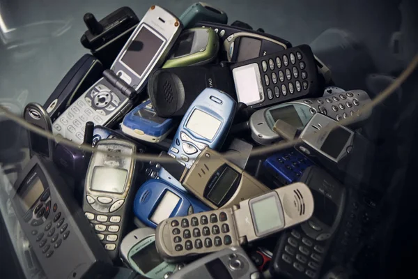 Milan Italy April 2019 - A group of old vintage mobile phones before smart phone revolution - recycling electronic device.