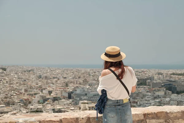 Woman or girl with smart-phone taking photo at the city of Athens from Acropolis in a sunny day in Greece. — Stock Photo, Image