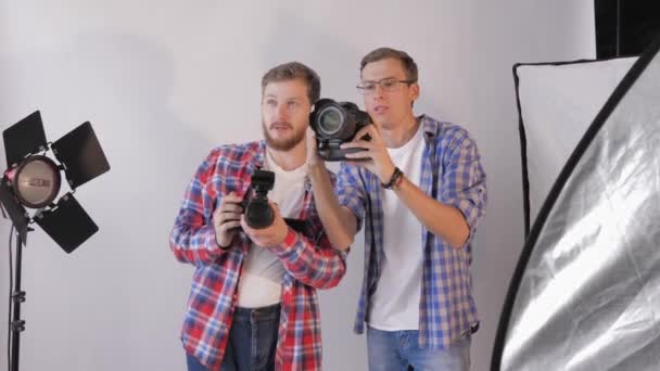 Fotografia mody, młodzi kreatywni fotografowie omawiający ramki podczas warsztatów w studiu fotograficznym — Wideo stockowe