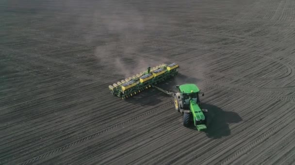 Tractor cultivating agricultural field in slow motion at spring time, view from height — Stock Video