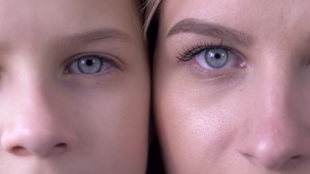 Age comparison, eyes of caucasian mother and daughter next to one another looking together at camera — Stock Video