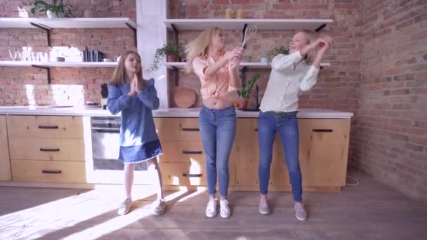 Szórakoztató idő anyával, vidám anya tánc lányaival és szórakozás a konyhában otthon hétvégén — Stock videók