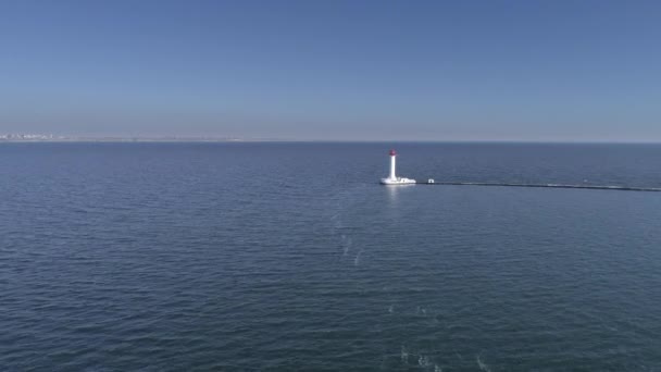 Hermosa vista del dron en el faro de mar en medio del agua contra el cielo azul — Vídeo de stock