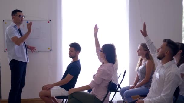 Successful people at training, speaker listens to young guy colleague about development of business ideas in room — Stock Video