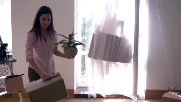 Νεαρό παντρεμένο ζευγάρι φέρνει κουτιά με πράγματα σε νέο διαμέρισμα μετά την ανακαίνιση και αγκαλιάζονται μεταξύ τους — Αρχείο Βίντεο