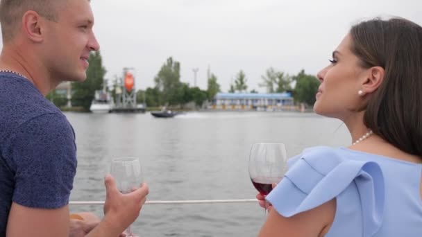 Rodinný pár pije víno na jachtě, šťastný pár pije červený nápoj na moři, dva lidé na dovolené — Stock video