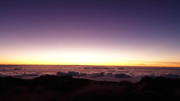 Amazing sunrise over floating white clouds in orange sky from mountain landscape in time lapse, aerial view — Stock Video