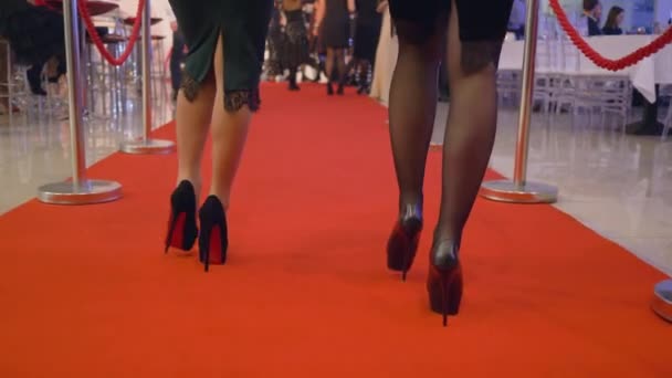 Celebrated event, gorgeous rich women in elegant dresses in high heels walk red carpet at expensive holiday — Stock Video