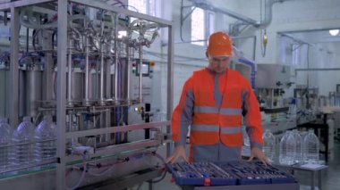 portrait of factory Engineer guy into helmet and coveralls with tools for renovate plant hardware