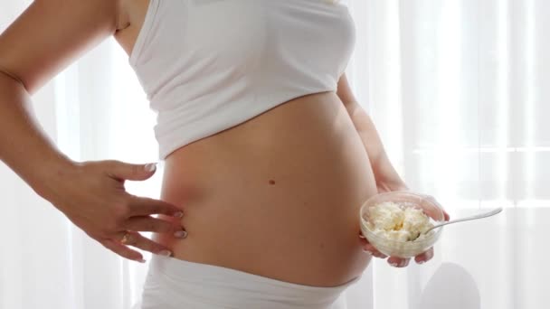 Pregnancy, sour milk products in hand of future mother — Stock Video