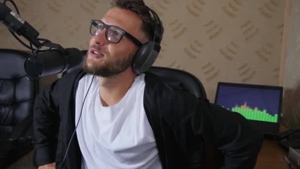 Cute radio presenter into glasses taking off headset in end of work day — Stock Video