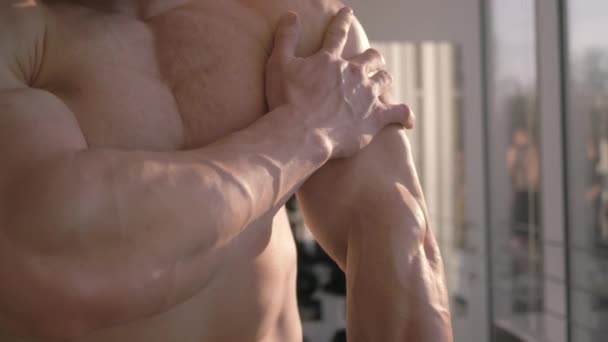 Profesionální kulturistika, sportovní muž považuje za výsledek posilování při budování svalů v tělocvičně v přirozeném světle — Stock video