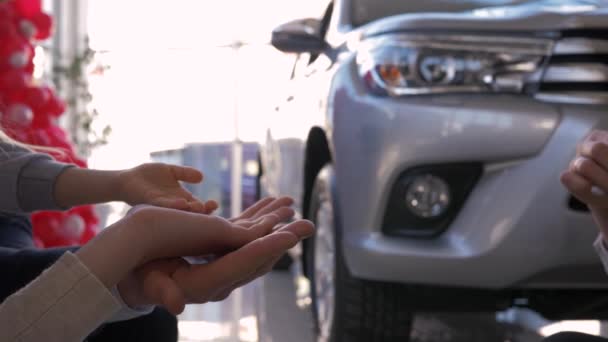Familie Autokauf, Autohändler gibt Schlüssel neues Auto an Besitzer Hände Eltern mit kleinem Kind gegen von Maschine im Verkaufszentrum — Stockvideo