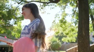 presenting surprise, girl with colorful balloons giving presents and congratulates girlfriend happy birthday