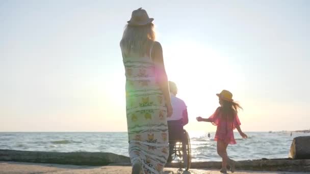 Invalid husband together with female and little girl embrace — Stock Video