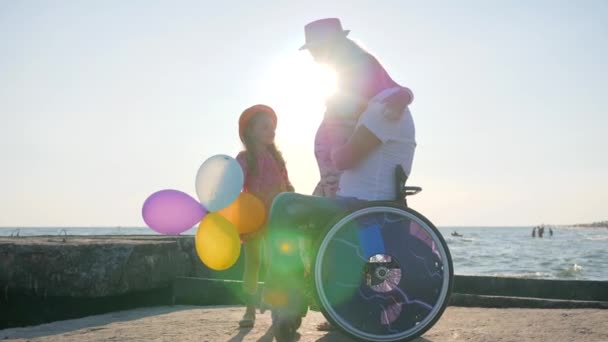 Lover handicapped in wheel chair with lucky Family child consider belly of pregnant mom vacation — Stock Video